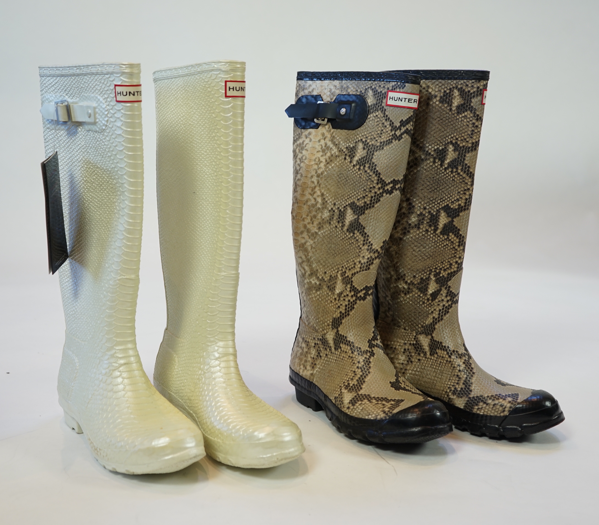 Two pairs of lady's Hunter snake-skin effect wellington boots, size UK 7